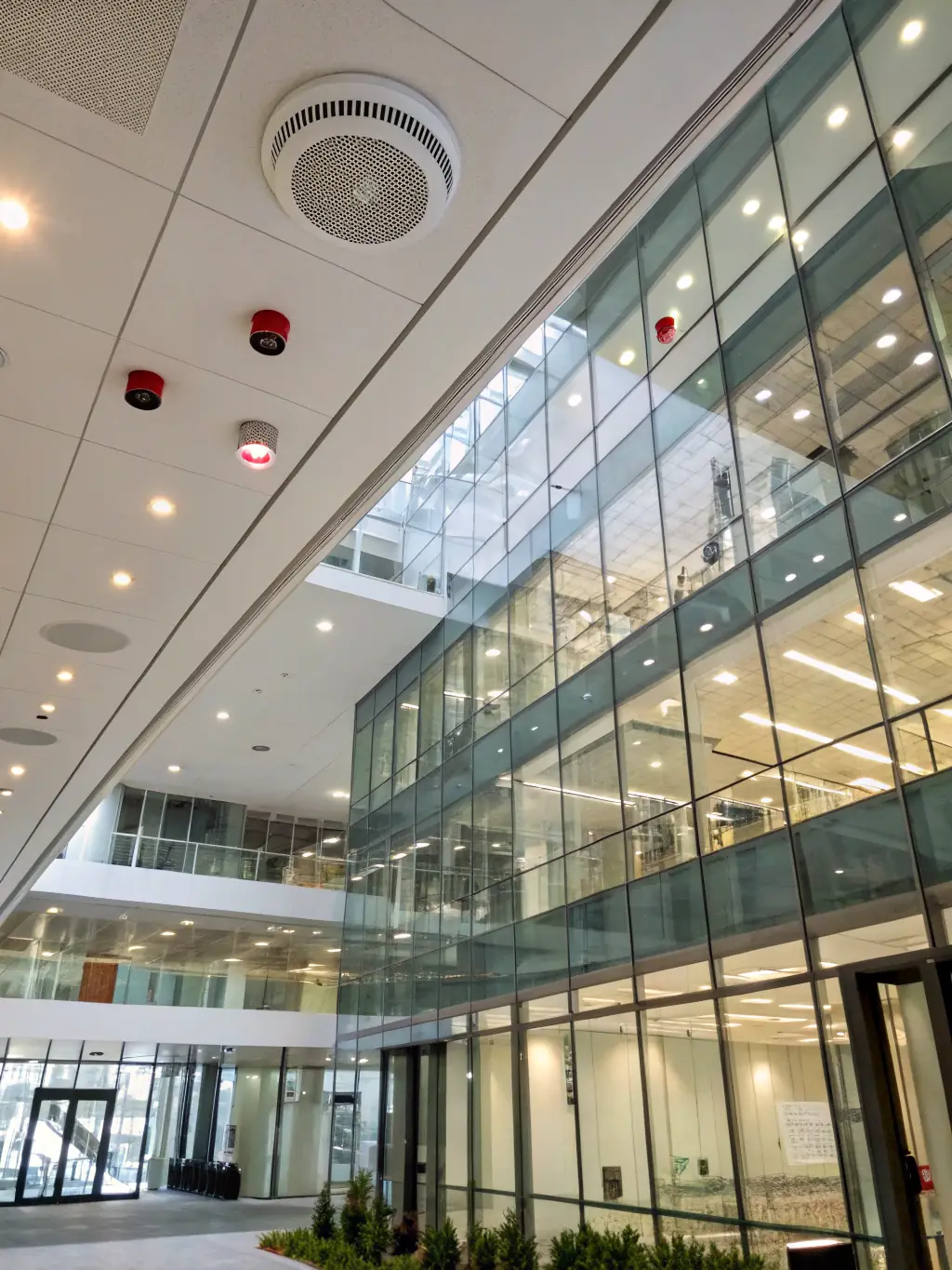 An image showing fire alarm panels and sprinkler systems in a commercial building, highlighting Akshayaguna Technologies' fire & safety solutions.